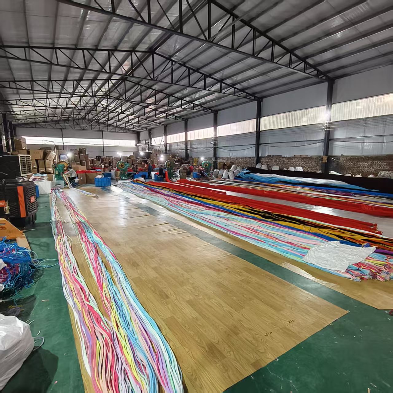 Factory floor with colorful chenille stem material arranged for processing