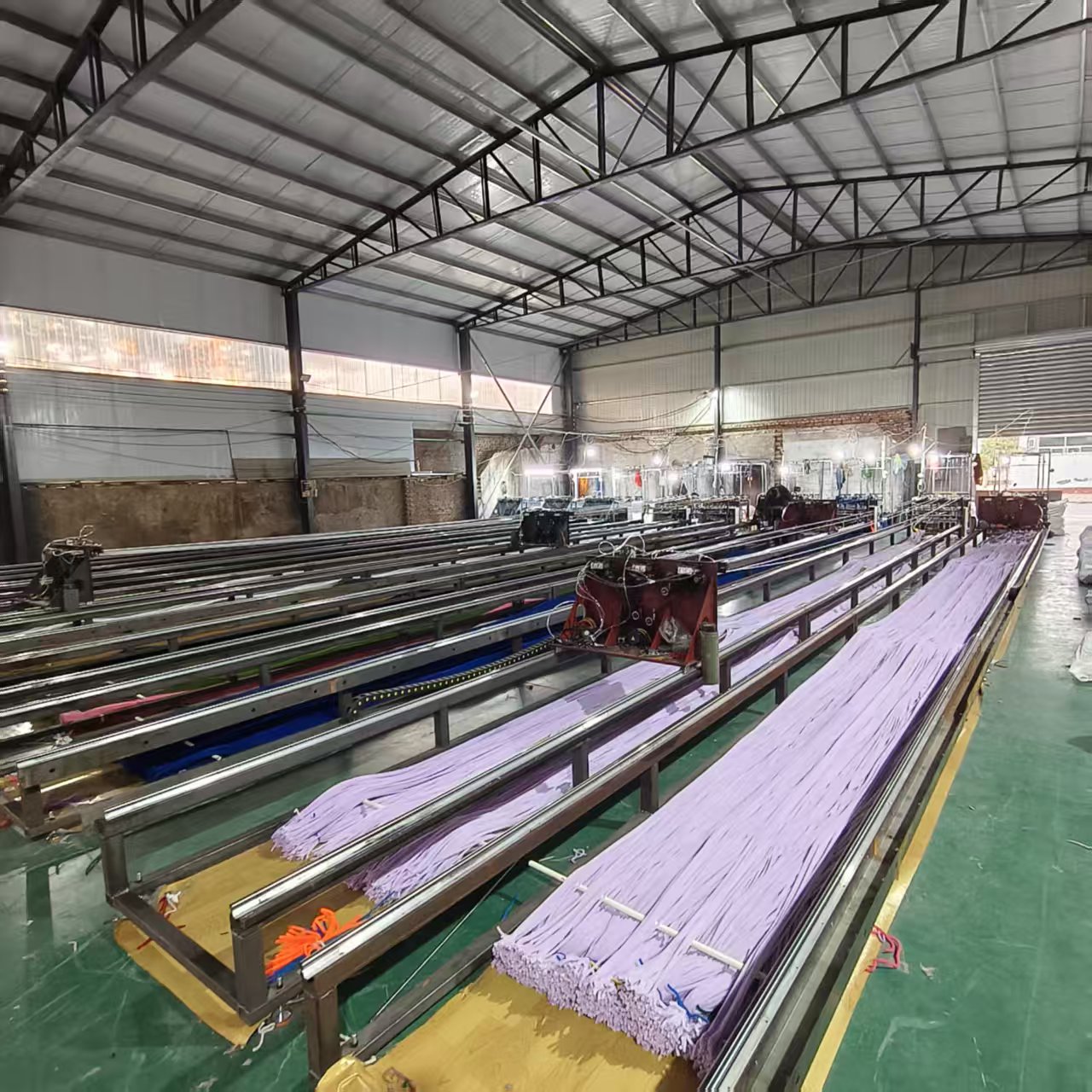 Purple chenille stem lines running through the production equipment