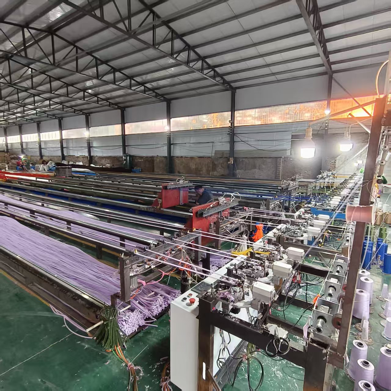 Chenille stem production machinery beside finished production lines